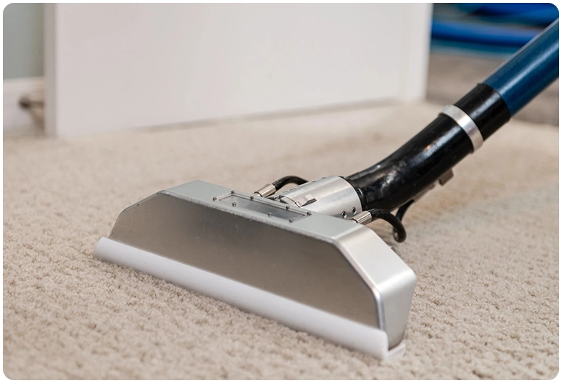 A carpet cleaning machine is on the floor.