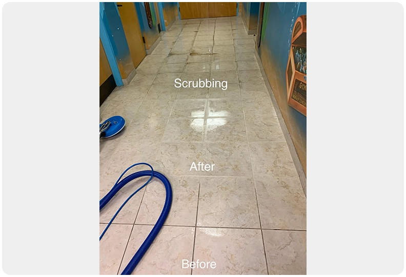 A tile floor with blue cleaning equipment on it.